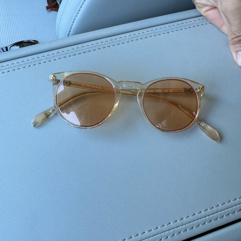 Stylish Transparent Oliver Peoples Sunglasses with Orange Lenses